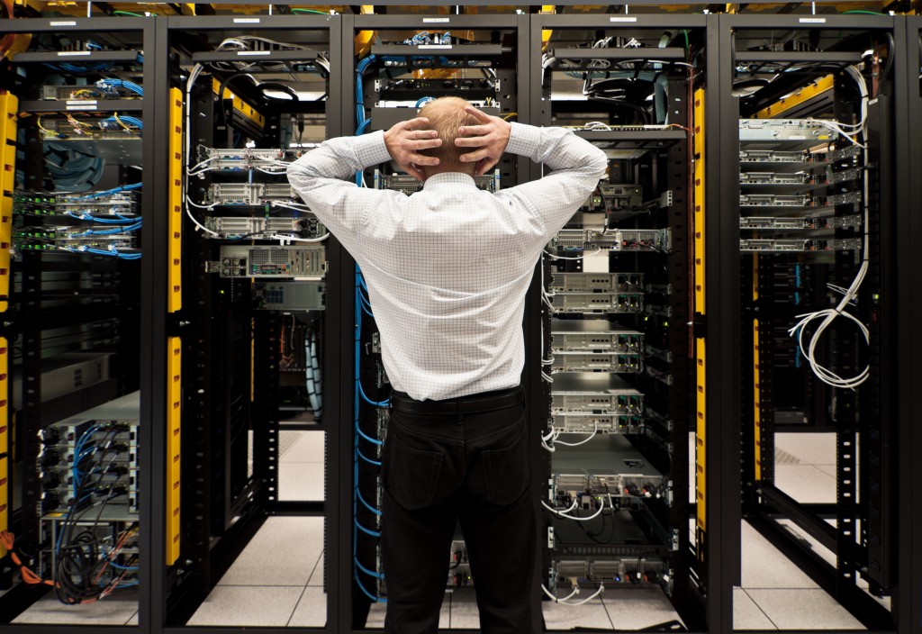 Frustrated employee looking at a network data center