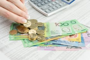 woman counting bills and coins