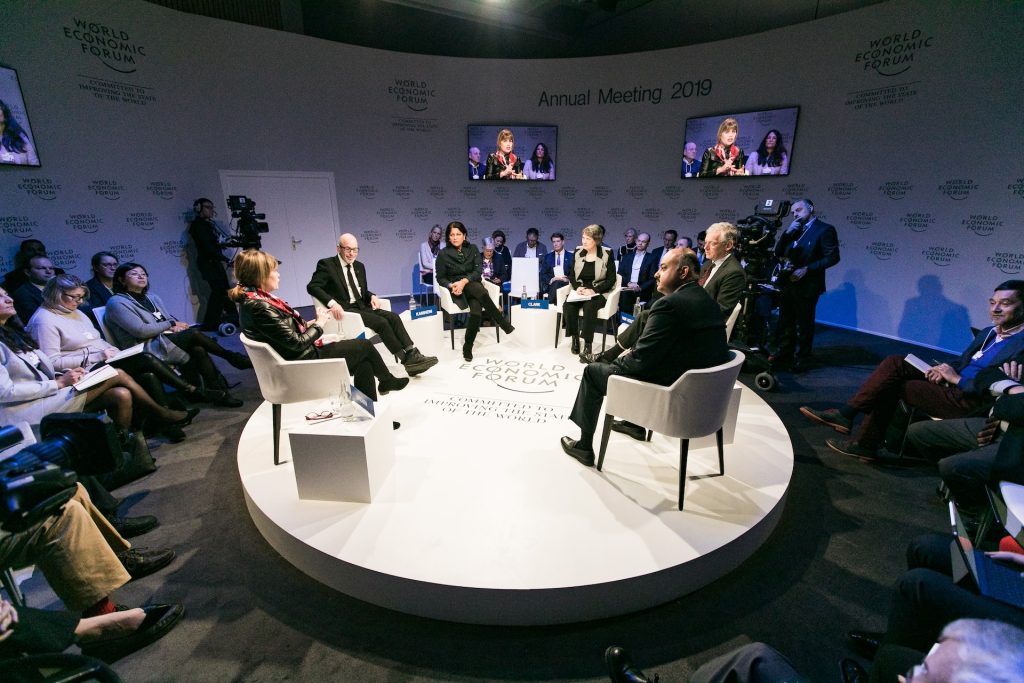 world economic forum with men and women in a circle