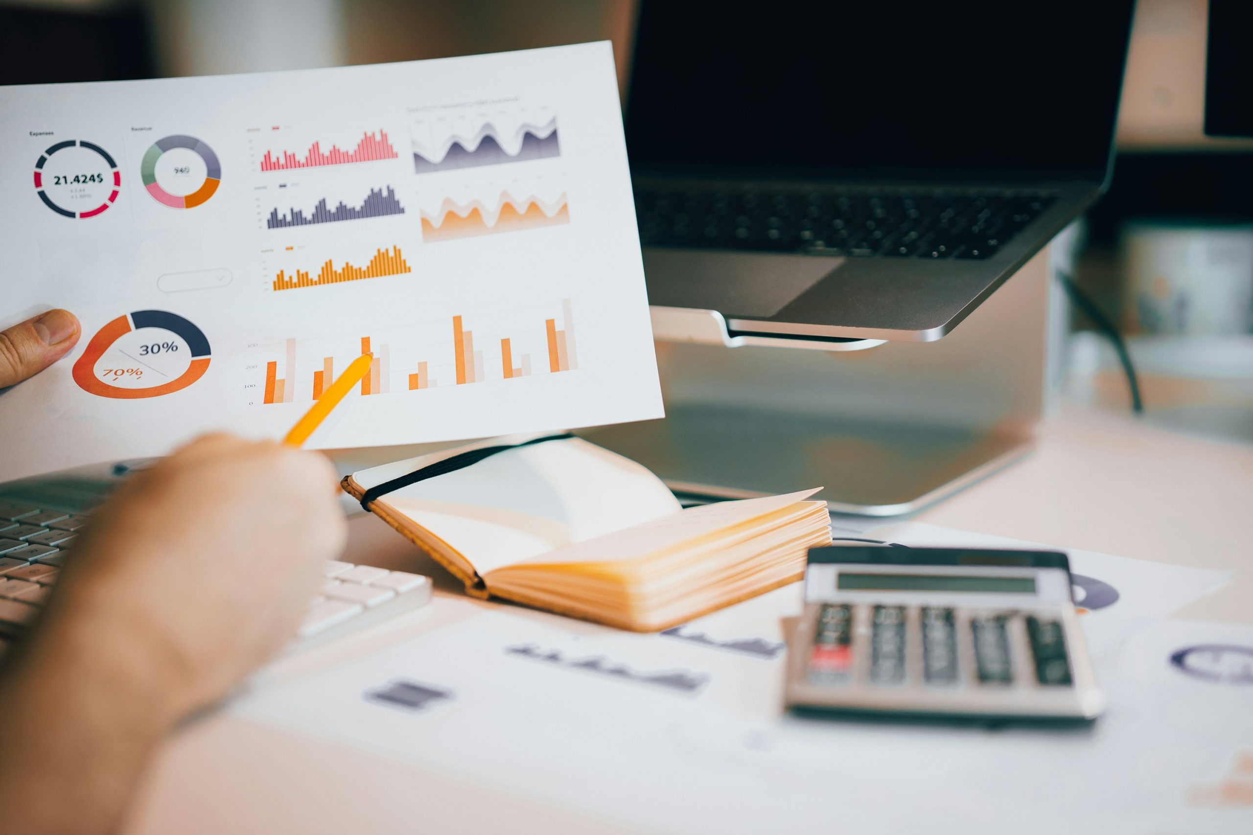 man holding a document with charts and graphs